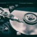 ModularDS vs UpdraftPlus: Which Backup Solution Reigns Supreme? 6 Close-up of a hard drive platter and actuator arm illustrating ModularDS vs UpdraftPlus: Which Backup Solution Reigns Supreme?